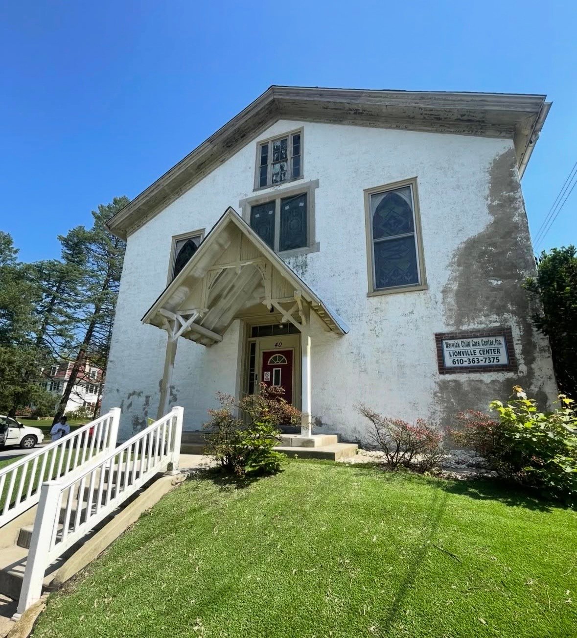 Commercial building before exterior repaint, showing worn and weathered stucco